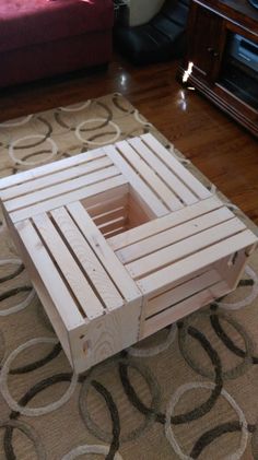 a coffee table made out of pallet wood sitting on top of a brown rug