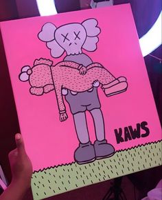 a person holding up a pink poster with an image of a cartoon character on it