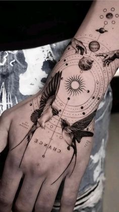 a person with a tattoo on their arm that has an image of birds flying around it