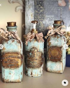 three old blue bottles are sitting on a table