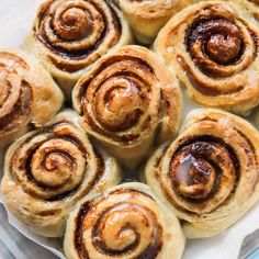 several cinnamon rolls on a white plate