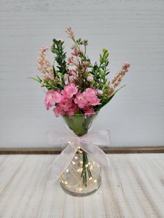 a vase filled with pink flowers on top of a table