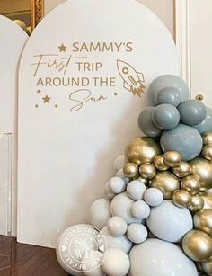 balloons are stacked on top of each other in front of a sign that says sammy's trip around the sun