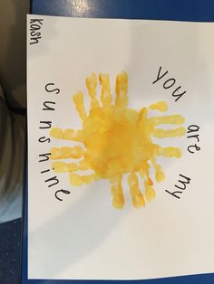 a child's handprint is displayed on a white paper