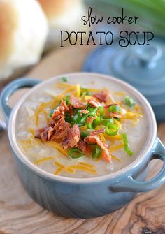 slow cooker potato soup with bacon and green peppers in a blue bowl on a wooden board