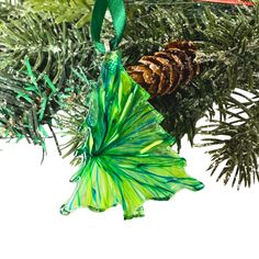 a pine cone ornament hanging from a christmas tree