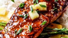 salmon and asparagus on top of rice with sauce