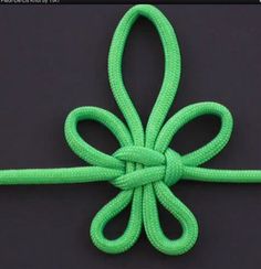 an image of a green knot tied to a black surface