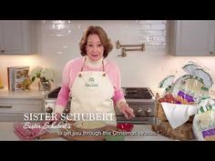 a woman standing in front of a counter with some food on it and the words sister schubert written above her