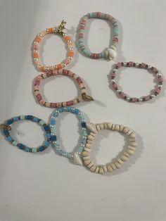 This is our beach bracelet collection! We have many different beach themed bracelets. They are all made with stretchy clear elastic string. Summer Beach Stackable Jewelry, White Adjustable Stretch Bracelet With Beachy Style, Adjustable Beaded Bracelets For Beach Season, Adjustable White Stretch Bracelet With Beachy Style, Multicolor Stackable Stretch Bracelet For Beach, White Stackable Beaded Bracelets For Beach, Stackable Casual Beaded Bracelets For Summer, Casual Multicolor Bracelets For Beach Party, Casual Stackable Beaded Bracelets For Summer