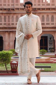 Featuring a cream sherwani in silk base with kashmiri embroidery. It is paired with matching  churidaar pants and a dupatta.  FIT: True to size. COMPOSITION: Silk. CARE: Dry clean only. Sherwani Dupatta For Men, Sherwani With Dupatta, Engagement Outfits Indian, Indian Wedding Look, Groom Indian Wedding Outfits, Cream Sherwani, Nikkah Outfit