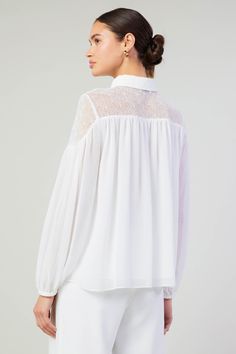 A lace paneled yoke accents this floaty blouse designed with a classic collar at the neck. It's relaxed and airy, enhanced by subtle gathers that create a beautiful drape. •Collared neckline •Button closure •Long sleeves •Elasticized cuffs •Relaxed fit Item number 2430145100% Polyester White Chic Lace Top With Sheer Sleeves, Chic White Lace Top With Sheer Sleeves, Feminine Lace Top Blouse, Sheer Blouse For Daywear, Chic White Blouse With Lace Sleeves, Feminine Wedding Blouse With Sheer Sleeves, White Lace Cuffs Blouse For Work, Feminine Lace Top With Sheer Sleeves, White Blouse With Lace Cuffs For Work