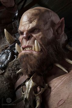 an image of a man with horns and fangs on his face, in the middle of a scene