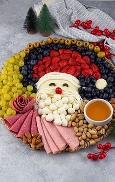 a platter filled with fruit, cheese and crackers