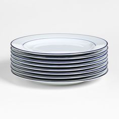 stack of blue and white plates stacked on top of each other in front of a white background