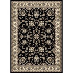 a black rug with white and beige designs on it