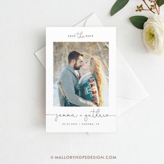 an image of a couple kissing on the forehead in front of some flowers and greenery