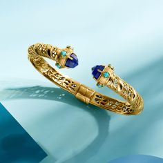 Ross-Simons - Lapis and Turquoise Cuff Bracelet in 18kt Gold Over Sterling. 8". A unique design comprised of classically luxurious elements, this cuff bracelet features gorgeous openwork detailing capped with 8mm round lapis and 3mm round stabilized turquoise cabochon decor. Crafted in textured and polished 18kt yellow gold over sterling silver with milgrain detailing. Natural pyrite flecks in lapis may vary. Hinged. Slip-on, turquoise and lapis cuff bracelet. Luxury Turquoise Bracelets With 17 Jewels, Luxury Blue Cuff Bracelet, Luxury Yellow Gold Cuff Bracelet With Gemstone, Luxury Blue Gemstone Bangle, Elegant Turquoise Multi-stone Bracelets, Luxury Multi-stone Cuff Bracelet Bangle, Luxury Cuff Bracelet Bangle With Gemstone Accents, Elegant Turquoise Bangle For Formal Occasions, Elegant Turquoise Cuff Bracelet With Gemstone