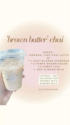 a person holding up a drink in front of a white background with the words brown butter chai on it