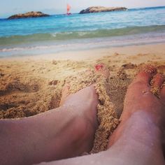 two feet in the sand at the beach