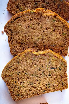 three slices of banana bread sitting on top of a cutting board