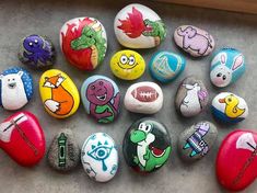 many different colored rocks with cartoon characters painted on them, including one for each rock