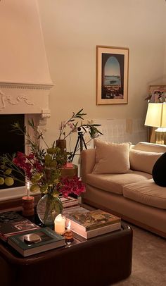 a living room filled with furniture and a fire place in front of a painting on the wall