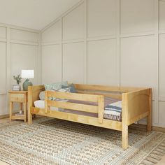 a wooden bed sitting on top of a rug next to a night stand and end table