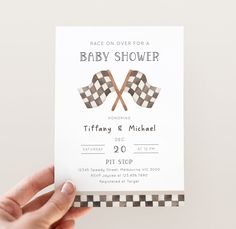 a hand holding up a baby shower card with checkered flags on it and the words race over for a baby shower