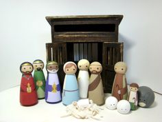 a group of wooden figurines sitting on top of a white table next to an old radio