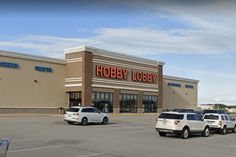 several cars parked in front of a hobby store