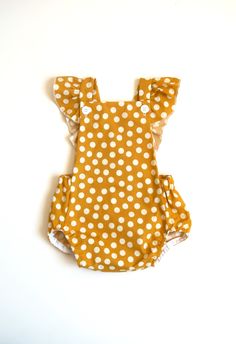 Add a pop of sunshine to your little one's wardrobe with our charming handmade yellow polka dot romper! Made from soft, breathable fabric, this romper is perfect for warm, sunny days and will keep your child feeling comfortable and stylish all day long. The romper features adorable fluttery straps that add a playful touch to the design. Whether it's a day at the park or a family picnic, your little one will look absolutely adorable in this cheerful romper. Wear it on it's own or with a bodysuit Birthday Romper, Spring Rompers, Polka Dot Romper, Romper Summer, Outfit Birthday, Yellow Romper, Baby Beach, Yellow Polka Dot, Ruffle Romper