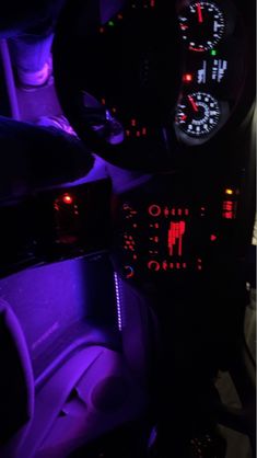 the interior of a car with purple lights and gauges on it's dashboard