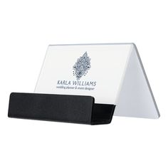 a white business card holder with a black base