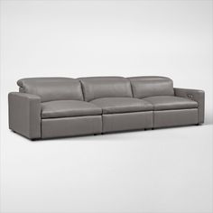 a grey leather couch with two reclinings on the back and one arm extended