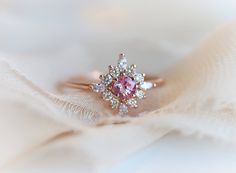 The perfect pink, sparkly, shimmering, unique and soon to be yours "Skylar" ring. The perfect Valentine's or Galentine's day gift! 💗 #pinkring #valentinesdayring #valentinesdaygift Pink Cluster Ring With Round Cut, Pink Cluster Promise Ring In Fine Jewelry Style, Pink Round Cluster Ring In Fine Jewelry Style, Pink Cluster Ring With Center Stone For Anniversary, Pink Cluster Diamond Ring, Pink Round Cluster Ring With Halo Setting, Luxury Pink Cluster Ring For Anniversary, Pink Cluster Diamond Ring For Wedding, Luxury Pink Cluster Ring As Gift