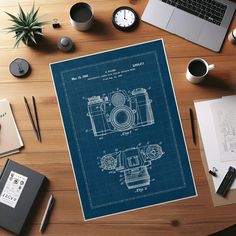 a blueprinted camera sits on top of a desk