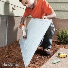 a man is painting the side of a house with an advertizer on it