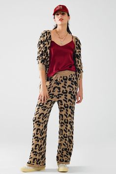 These leopard print pants with a stretchy knit and drawstring detail bring comfort and style together effortlessly. The bold animal print adds a trendy, eye-catching element to your look, while the flared design offers a flattering silhouette with a touch of retro flair. Perfect for casual days or lounging in style, these pants are as comfy as they are fashionable, thanks to the soft and chunky knit fabric.  Crafted from a blend of 49% polyester, 20% polyamide, 20% acrylic, 8% wool, and 3% elastane, these pants provide the perfect amount of stretch and warmth, making them ideal for cooler days. The regular-rise waist with an elastic waistband and tie fastening ensures a snug and adjustable fit, while the full-length design elongates the legs for a flattering effect.  The model is wearing s Satin Spaghetti Strap Top, Tan Scarf, Panther Print, Leopard Print Pants, Spaghetti Strap Top, Print Pants, Satin Top, Strap Top, Strap Tops