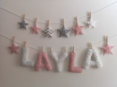 a baby's name made out of fabric stars and moon