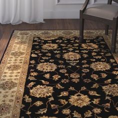 a black and gold rug in front of a window