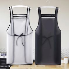 two aprons sitting on top of a counter next to each other