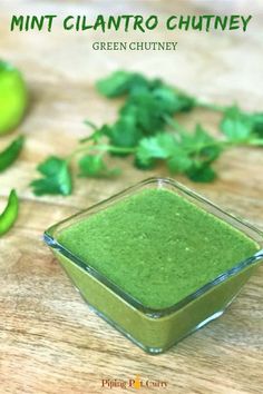 green chutney in a glass bowl on a wooden table