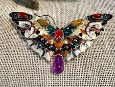 Brooch Outstanding Sterling vintage Enameled Butterfly with bezel set Carnelian and Tigereye with an Amethyst drop.  Condition is very good, safety catch works, pictures show the details.  Size approx. 2 2/3" by 1 1/2", wt.-  9.2 grams.  One of the nicest vintage enameled sterling Butterfly pins I've seen.  Butterflies symbol for transformation, lightness and JOY! Multicolor Enamel Brooch Jewelry, Elegant Multicolor Collectible Brooches, Vintage Multicolor Cabochon Jewelry, Multicolor Cabochon Brooch As Gift, Multicolor Cabochon Brooch For Gift, Multicolor Cabochon Brooches For Collectors, Multicolor Cabochon Brooches For Gifts, Multicolor Cabochon Brooches As Gift, Antique Multicolor Brooch Jewelry