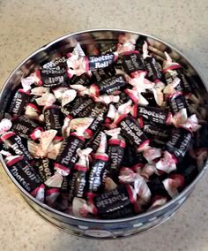 a bowl full of chocolate candy sitting on top of a table