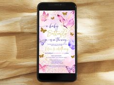 a phone with a pink and purple butterfly wedding card on it