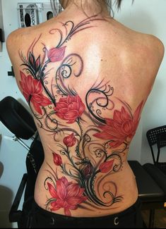 a woman's back with flowers and swirls on it