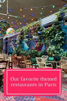 the interior of a restaurant with tables and chairs in front of plants on the wall