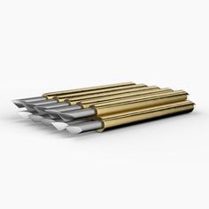 four gold and silver pencils sitting on top of each other