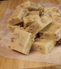 a pile of fudges sitting on top of a wooden cutting board